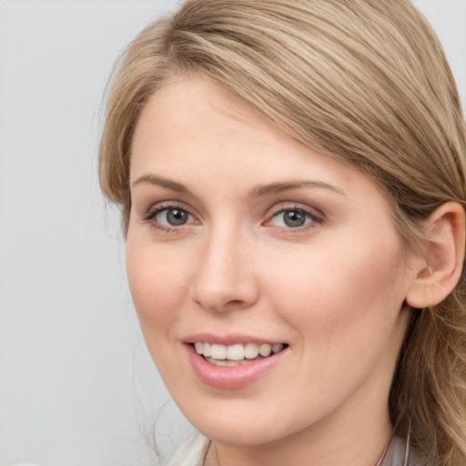 Joyful white young-adult female with long  brown hair and blue eyes