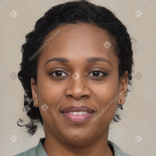 Joyful black young-adult female with long  brown hair and brown eyes