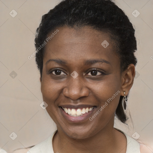 Joyful black young-adult female with short  brown hair and brown eyes