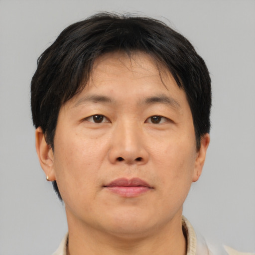 Neutral asian adult male with short  brown hair and brown eyes