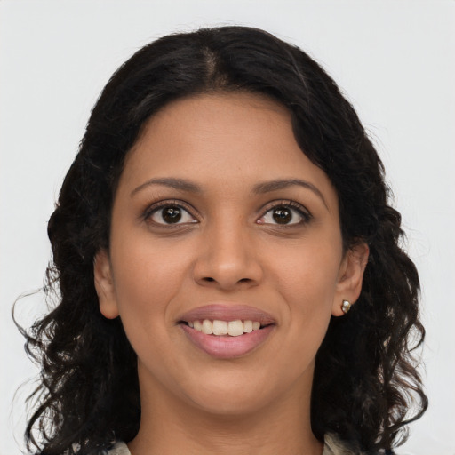 Joyful latino young-adult female with long  brown hair and brown eyes