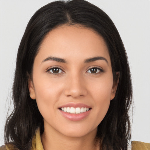 Joyful white young-adult female with long  brown hair and brown eyes