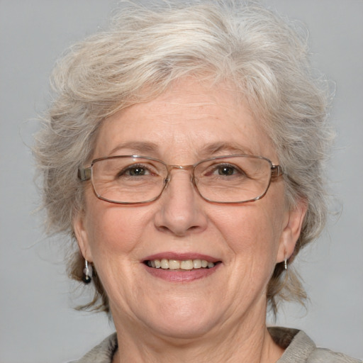 Joyful white middle-aged female with medium  gray hair and blue eyes