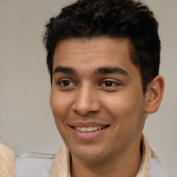 Joyful white young-adult male with short  black hair and brown eyes