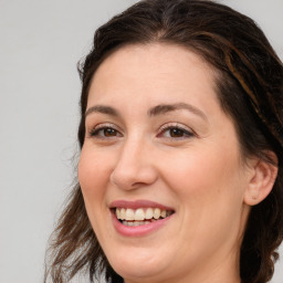 Joyful white adult female with medium  brown hair and brown eyes