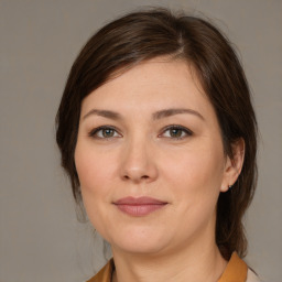 Joyful white young-adult female with medium  brown hair and brown eyes