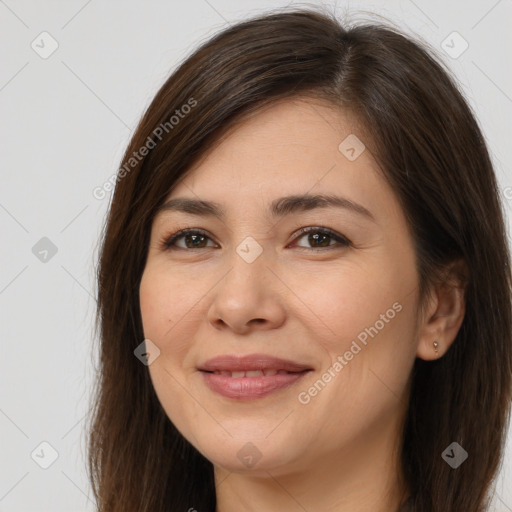 Joyful white young-adult female with long  brown hair and brown eyes