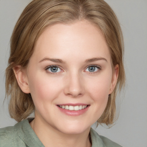 Joyful white young-adult female with medium  brown hair and blue eyes