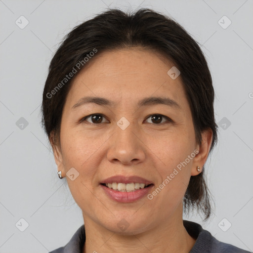 Joyful asian adult female with medium  brown hair and brown eyes