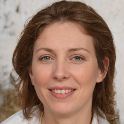 Joyful white adult female with medium  brown hair and grey eyes