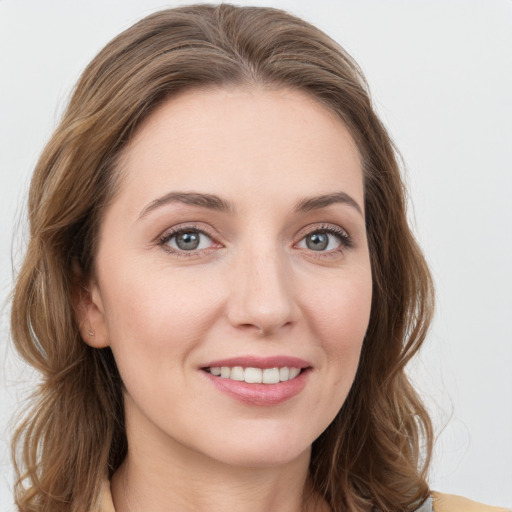 Joyful white young-adult female with long  brown hair and green eyes