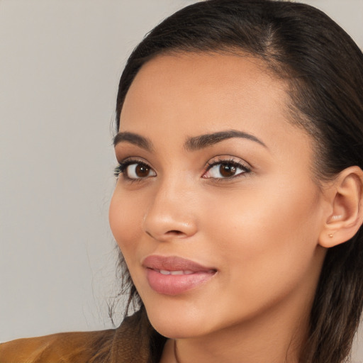 Joyful latino young-adult female with long  brown hair and brown eyes