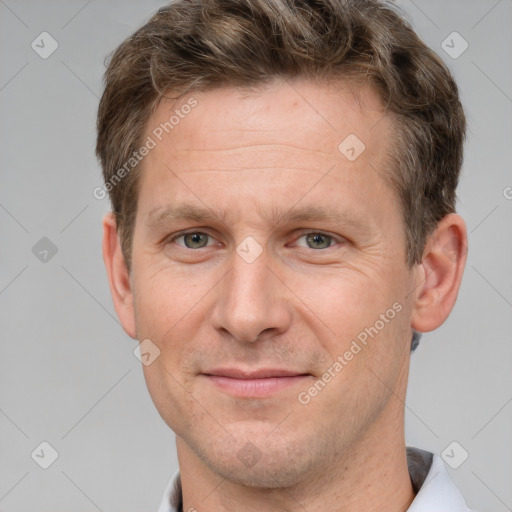 Joyful white adult male with short  brown hair and grey eyes