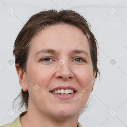 Joyful white adult female with medium  brown hair and grey eyes