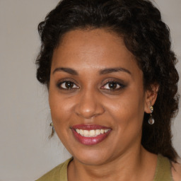 Joyful black young-adult female with medium  brown hair and brown eyes