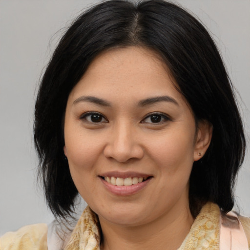 Joyful asian young-adult female with medium  brown hair and brown eyes