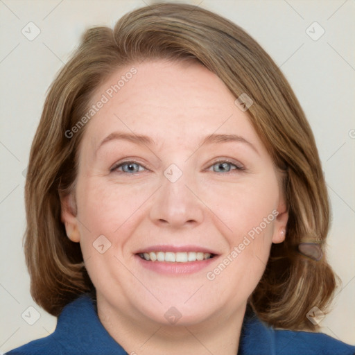 Joyful white adult female with medium  brown hair and blue eyes