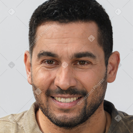 Joyful white adult male with short  black hair and brown eyes