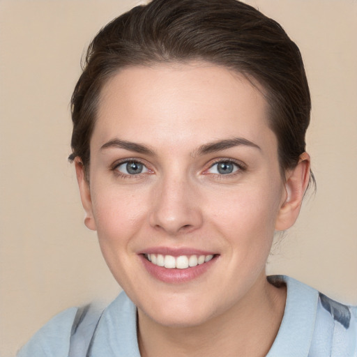 Joyful white young-adult female with short  brown hair and grey eyes