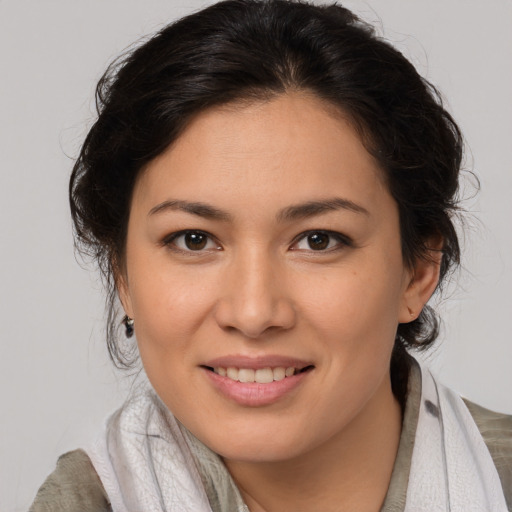 Joyful white young-adult female with medium  brown hair and brown eyes