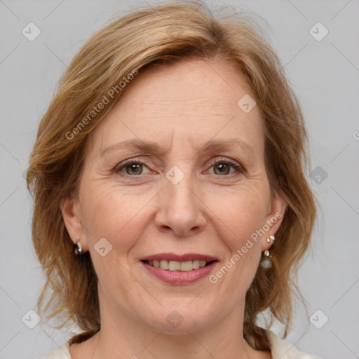 Joyful white adult female with medium  brown hair and blue eyes