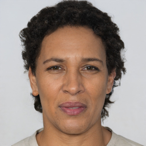 Joyful latino adult female with short  brown hair and brown eyes