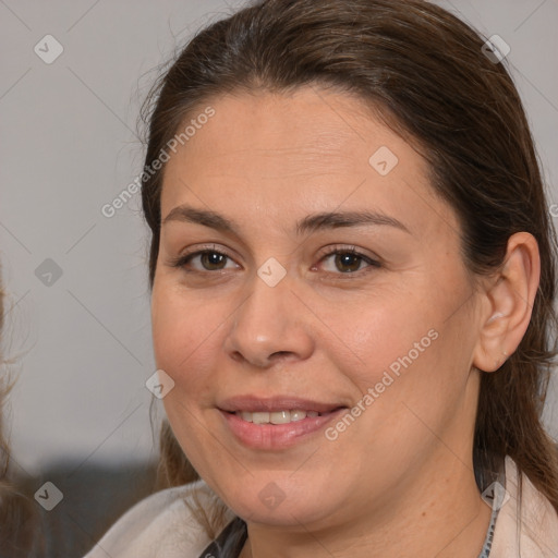 Joyful white adult female with medium  brown hair and brown eyes