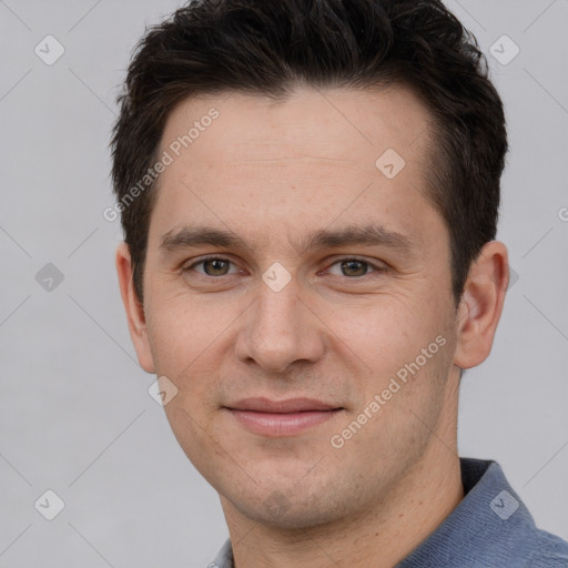 Joyful white young-adult male with short  brown hair and grey eyes