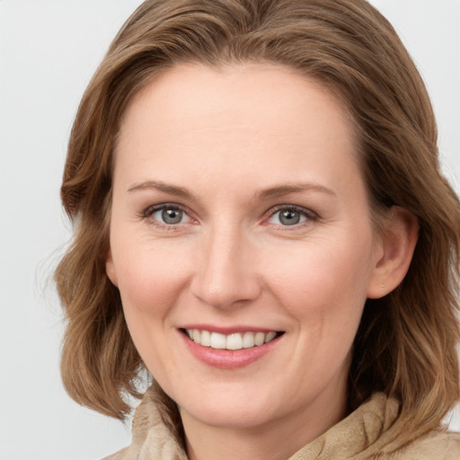 Joyful white young-adult female with medium  brown hair and green eyes