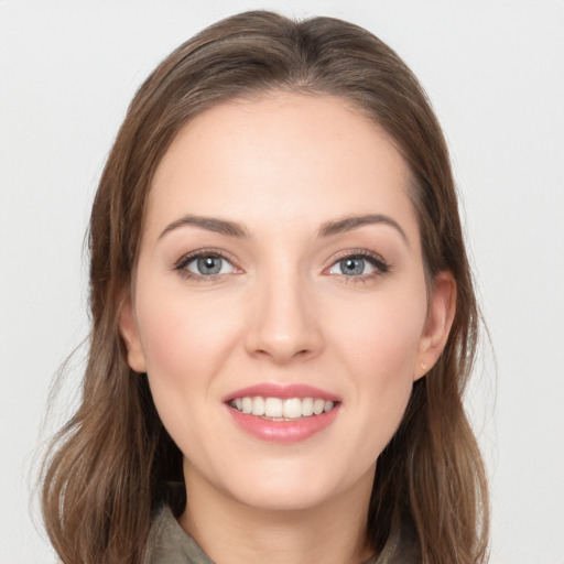 Joyful white young-adult female with long  brown hair and grey eyes