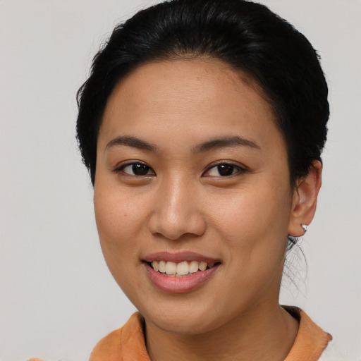 Joyful asian young-adult female with short  brown hair and brown eyes