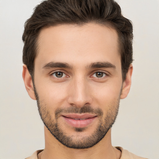 Joyful white young-adult male with short  brown hair and brown eyes