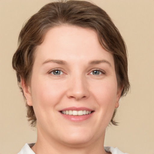 Joyful white young-adult female with medium  brown hair and green eyes