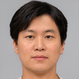 Neutral asian young-adult male with short  brown hair and brown eyes