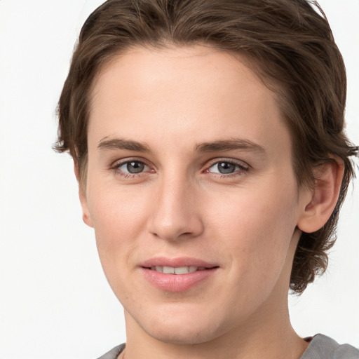 Joyful white young-adult female with medium  brown hair and grey eyes