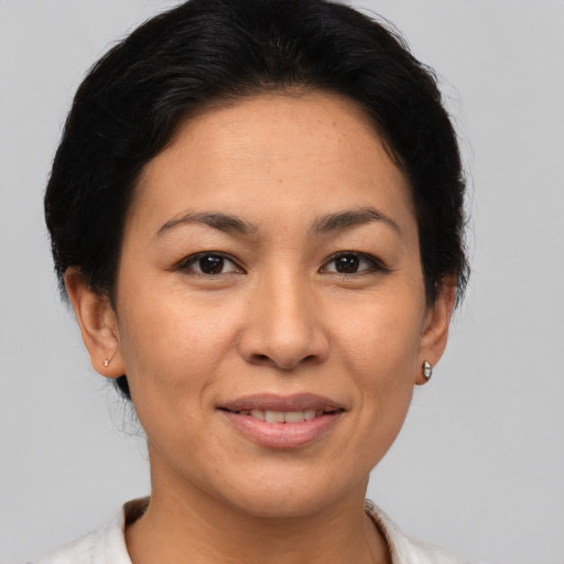 Joyful asian adult female with short  brown hair and brown eyes