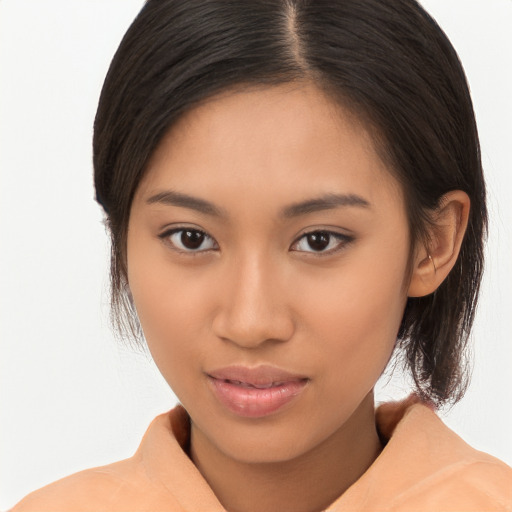 Joyful latino young-adult female with medium  brown hair and brown eyes