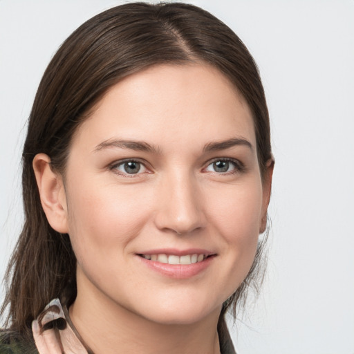 Joyful white young-adult female with medium  brown hair and grey eyes