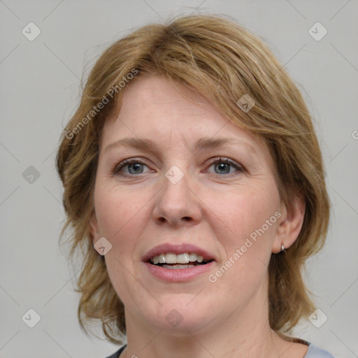 Joyful white adult female with medium  brown hair and blue eyes