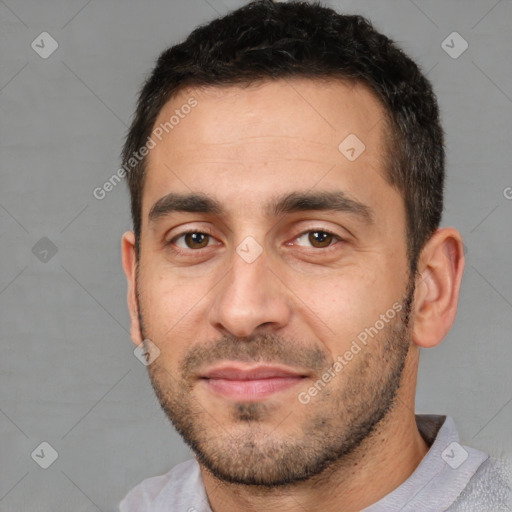 Joyful white young-adult male with short  black hair and brown eyes