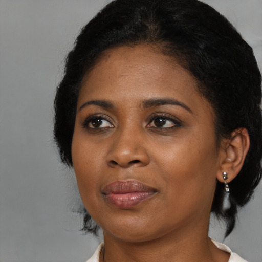 Joyful black young-adult female with medium  black hair and brown eyes