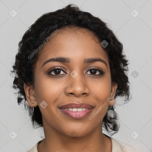 Joyful black young-adult female with long  black hair and brown eyes