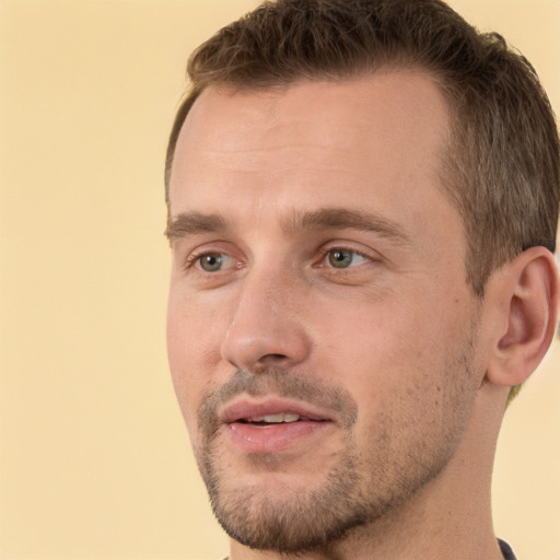 Joyful white young-adult male with short  brown hair and brown eyes