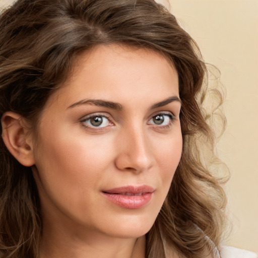 Joyful white young-adult female with long  brown hair and green eyes