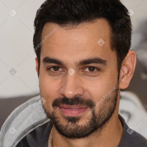 Joyful white young-adult male with short  brown hair and brown eyes