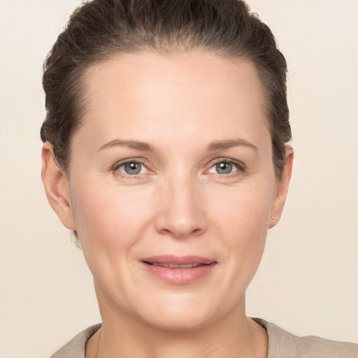 Joyful white adult female with short  brown hair and grey eyes