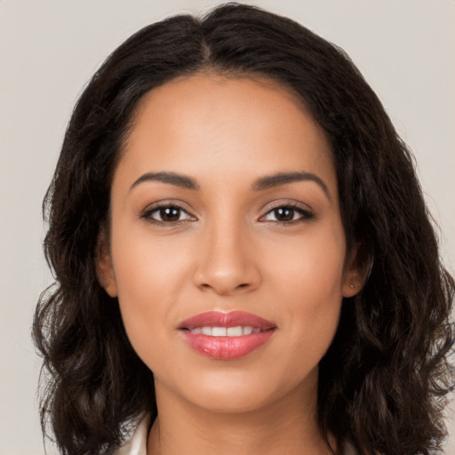 Joyful latino young-adult female with long  brown hair and brown eyes