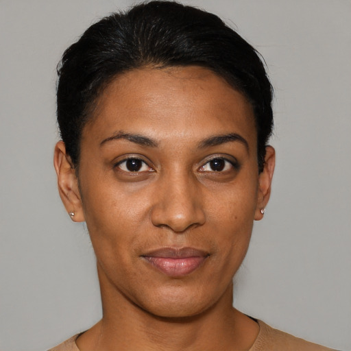 Joyful black young-adult female with short  black hair and brown eyes