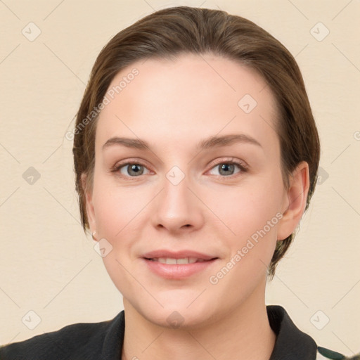 Joyful white young-adult female with medium  brown hair and grey eyes