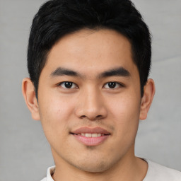 Joyful asian young-adult male with short  black hair and brown eyes